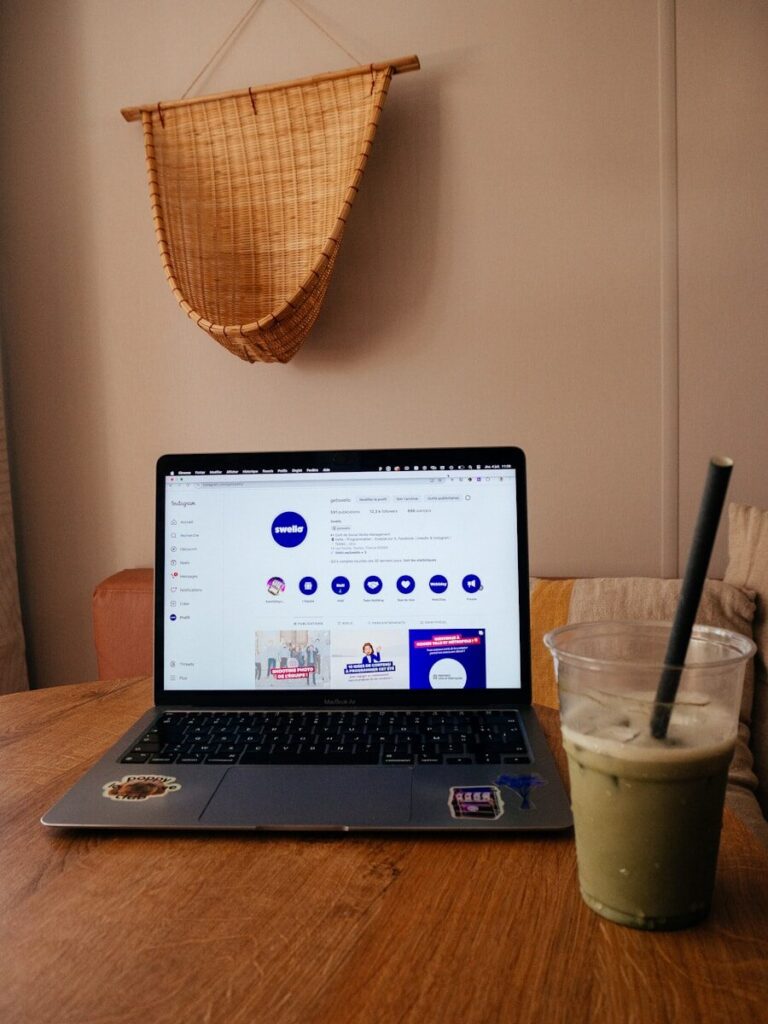 A laptop computer sitting on top of a wooden table