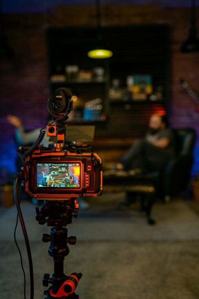 black and orange camera on black tripod