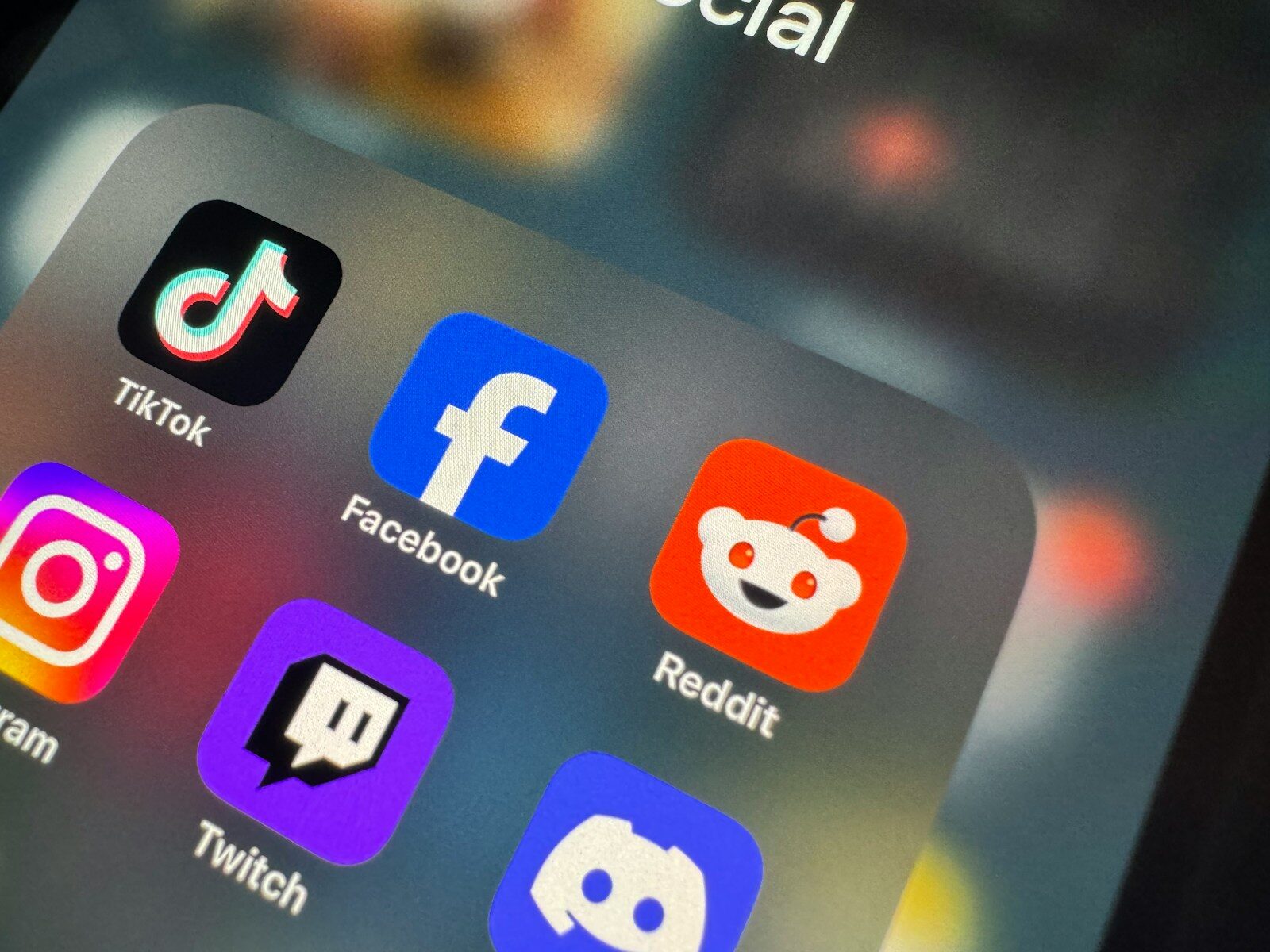 a close up of a cell phone with social icons on it