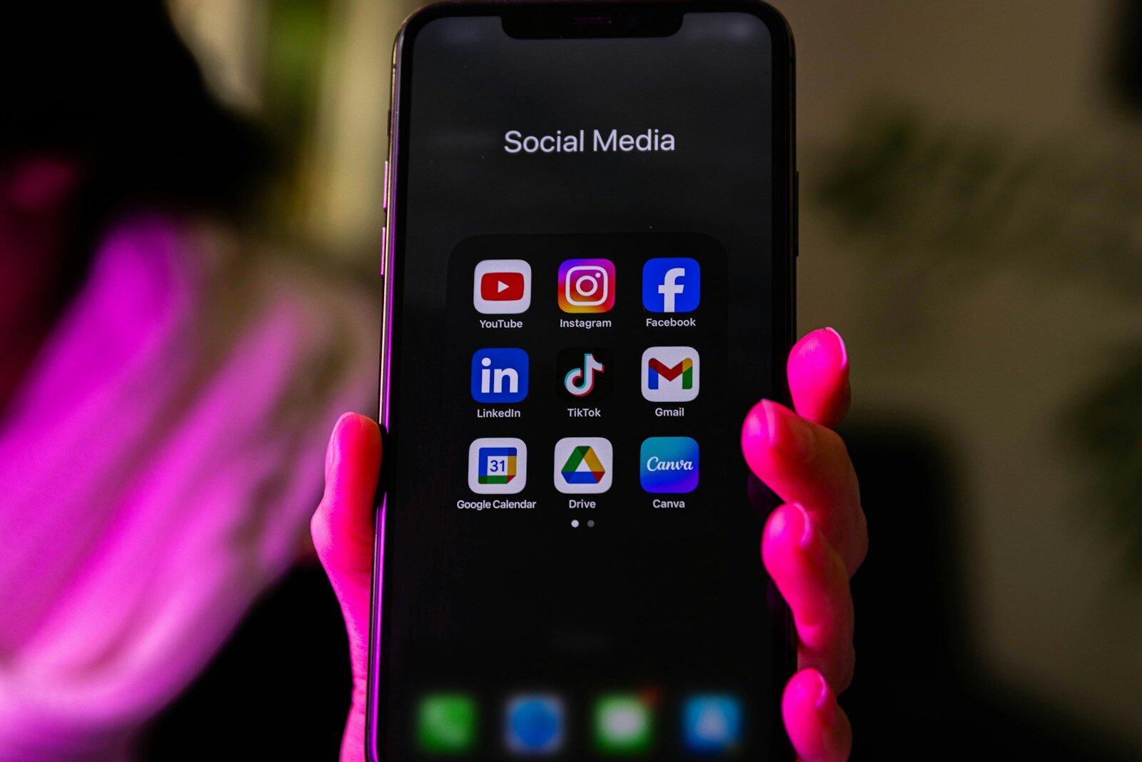 A smartphone displays social media app icons