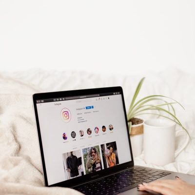 a laptop computer sitting on top of a bed