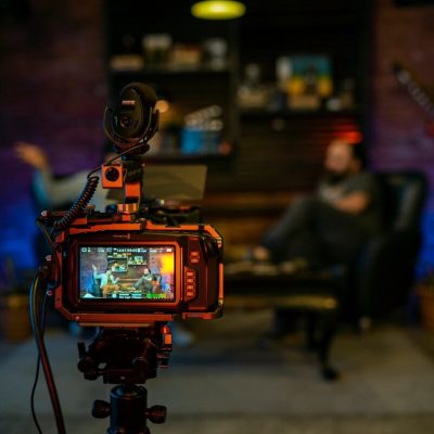 black and orange camera on black tripod