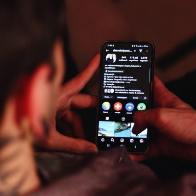 A person holding a cell phone in their hand