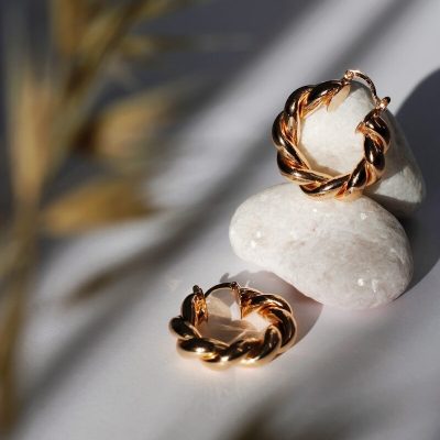 gold ring on white textile