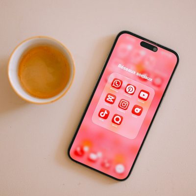 Coffee cup and smartphone with pink app icons