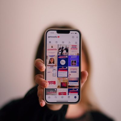 a woman holding up a cell phone in front of her face