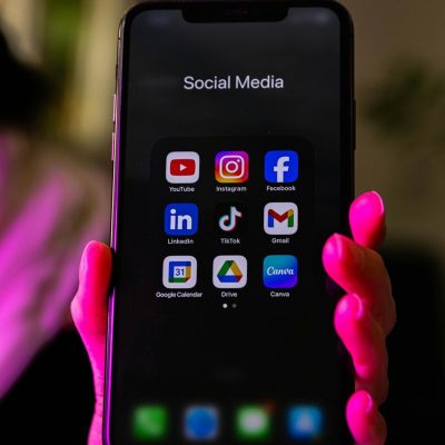 A smartphone displays social media app icons